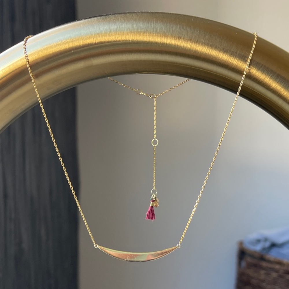 Elegant Gold Necklace with Red Tassel